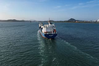 In this aerial view a cargo ship enters the Panama Canal on the Pacific Ocean side in Panama City on February 4, 2025. Two Panamanian lawyers filed a complaint Monday to cancel the concession of a Hong Kong-based company for operating two ports on the Panama Canal, following US President Donald Trump's threats to seize the vital waterway. (Photo by MARTIN BERNETTI / AFP)
