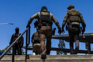 Immigration and Customs Enforcement (ICE) agents walk outside the Ventura County Government Center in Ventura, California, on July 27, 2026. The Ventura County Government Center has been the site of tense standoffs and confrontations in recent weeks between US Immigration and Customs Enforcement (ICE) agents, local community observers, and protesters. (Photo by Blake Fagan / AFP)