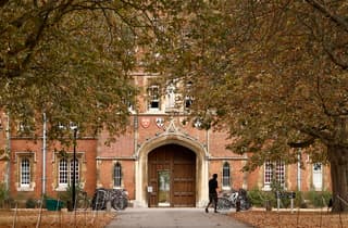 A person walks past Jesus College, where black academic Jason Arday was a Fellow, at the University of Cambridge in Cambridge, eastern England on August 15, 2026. Cambridge's top administrator Vice-Chancellor Deborah Prentice said Friday the UK university was "desperately saddened" by the death of Jason Arday, an academic who quit the prestigious institution last week amid a plagiarism scandal. (Photo by Brook Mitchell / AFP)