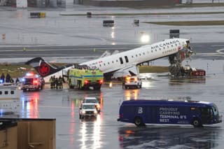 (FILES) An Air Canada Express CRJ-900 sits on the runway after colliding with a Port Authority fire truck at LaGuardia Airport in New York, on March 23, 2026. Two air traffic controllers left work early ahead of the deadly collision between an Air Canada jet and a fire truck at New York's LaGuardia Airport in March, The Wall Street Journal reported on August 27, 2026. (Photo by TIMOTHY A. CLARY / AFP)