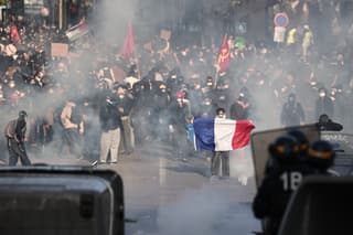Protesters hold Palestinian and French national flags as they confront French Republican Security Corps (CRS - Compagnies Republicaines de Securite) officers during a demonstration in favor of purchasing power, the protection of public services, and fiscal and social justice, in Marseille, southeastern France on October 24, 2026 as part of a nationwide call for mobilisation bringing together former members of the Yellow Vest movement, labor unions, high school and university students. Protests by high school students over learning conditions sparked a movement that has since spread nationwide, fuelled by broader anger over the rising cost of living. About 70,000 security personnel will be deployed on October 24, 2026, Interior Minister said at a news conference, warning that calls for violence and looting were circulating on social media. (Photo by Thibaud MORITZ / AFP)