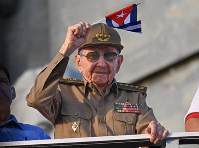 Cuba's former President Raul Castro waves a Cuban national flag during the commemoration of May Day (Labour Day), marking International Workers' Day, at Havana's Revolution Square on May 1, 2025. (Photo by YAMIL LAGE / AFP)