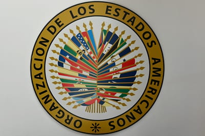 The logo of the Organization of American States (OAS or OEA) is pictured at the hall of offices of the Mission to Support the Peace Process in Colombia (MAPP) in Bogota on April 21, 2026. (Photo by Pablo VERA / AFP)