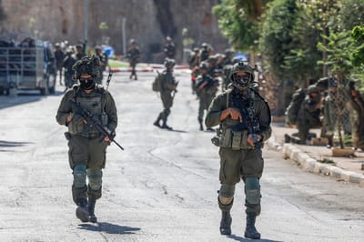 Israeli soldiers patrol a street as they are deployed during an operation in the village of Qusra, south of Nablus, in the Israeli-occupied West Bank, on August 13, 2026. Israeli forces on August 13 moved against rogue settlers laying siege to Palestinians amid unusually strong US criticism, even as Israel inaugurated an emblematic settlement elsewhere in the West Bank. Settlers at Qusra near Nablus since August 9 have blockaded Palestinian homes, including one owned by a US citizen, with residents saying they have been cut off from food and other supplies. (Photo by Zain JAAFAR / AFP)