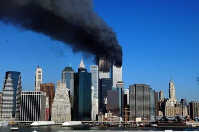 (FILES) The twin towers of the World Trade Center billow smoke after hijacked airliners crashed into them early on September 11, 2001. September 11, 2026, will mark the 25th anniversary of the September 11, 2001, attacks that killed nearly 3,000 people in New York, Washington and Pennsylvania. (Photo by HENNY RAY ABRAMS / AFP)