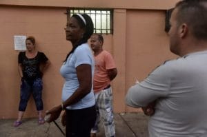 Cuban migrants, who reached Panama in their attempt to get to the United States, socialize in the Pastoral Social Caritas Panama shelter in Panama City on January 12, 2017. US President Barack Obama on January 12, 2017 ended a decades old policy for Cuban immigrants, who will now face similar restrictions to other citizens from Latin America. / AFP PHOTO / RODRIGO ARANGUA