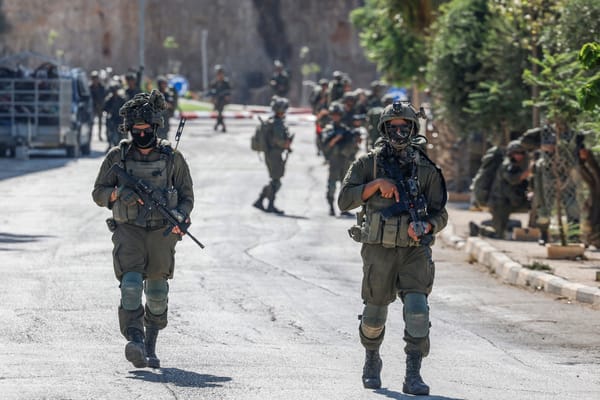 Israeli soldiers patrol a street as they are deployed during an operation in the village of Qusra, south of Nablus, in the Israeli-occupied West Bank, on August 13, 2026. Israeli forces on August 13 moved against rogue settlers laying siege to Palestinians amid unusually strong US criticism, even as Israel inaugurated an emblematic settlement elsewhere in the West Bank. Settlers at Qusra near Nablus since August 9 have blockaded Palestinian homes, including one owned by a US citizen, with residents saying they have been cut off from food and other supplies. (Photo by Zain JAAFAR / AFP)